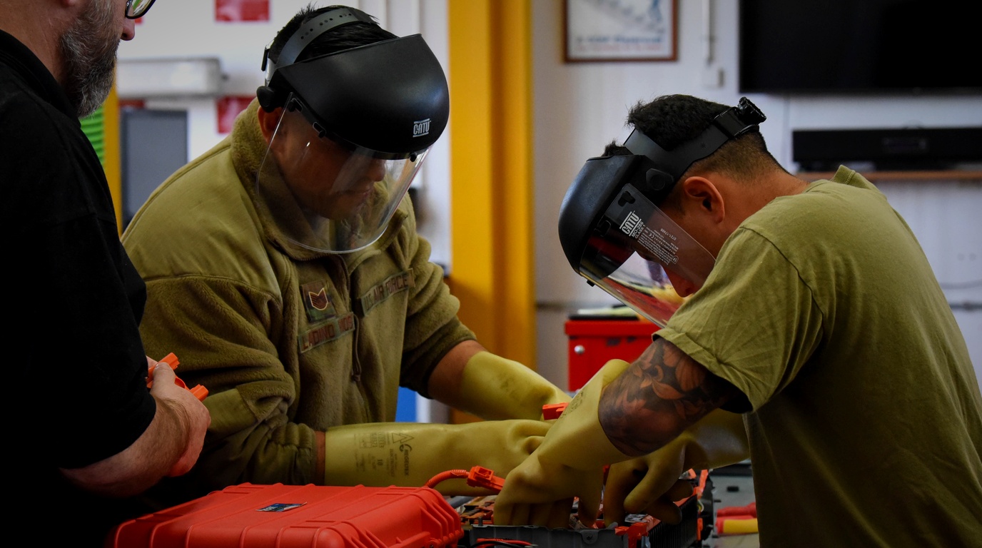 Automotive technicians conducting high-voltage EV powertrain maintenance training